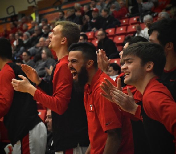 Tribune Chronicle / John Vargo YSU senior point guard Francisco Santiago, center, is out for the season with an ACL tear to his right knee. Santiago cheers on his team during Thursday's win against Milwaukee. Teammates Jacob Brown, left, and John Kirinic, right, are also pictured.